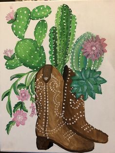 a painting of cowboy boots with flowers and cacti