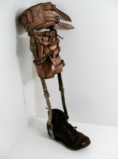 an old pair of shoes is attached to a sculpture