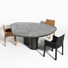 an oval table with two chairs around it and one chair sitting at the base next to it