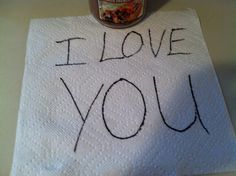 i love you written on a towel next to a jar of peanut butter