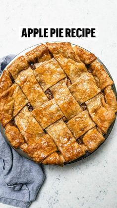 a pie sitting on top of a table next to a blue towel and a napkin