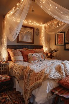 a bedroom with lights strung from the ceiling and a bed covered in blankets, pillows and blankets