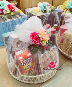 three baskets with flowers and candy in them