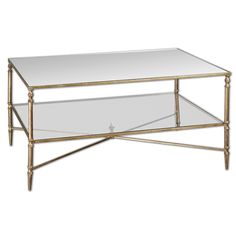 a gold and glass coffee table with two shelves on each side, one shelf holding a mirror