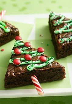 there is a piece of cake with green icing on it and candy canes in the foreground