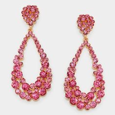 These Big Pink Crystal Pageant Hoop Earrings are a unique and eye-catching addition to your jewelry collection. They feature pink crystal embellishments on a gold backing, and measure 1.5" in width and 3.75" in length. The earrings come with a post back closure for added security. Make a bold statement with these glamorous crystal hoop earrings. Purple Statement Earrings, Light Pink Earrings, Pink Earring, Pink Statement Earrings, Gold Rhinestone Earrings, Purple Dangle Earrings, Pageant Earrings, Collage Elements, Black Earrings Dangle