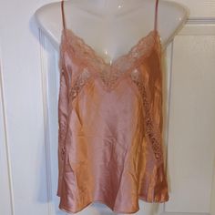 Feminine & Sexy Camisole In A Dusty Pink To Wear Alone Or Under All Of Your Pretty Tops. It Has Adjustable Straps For A Great Fit And The Lace Will Look Beautiful Peeking Out Of Your Low Cut Top. *Flat Measurements: -Pit To Pit - 16.5" Unstretched -Length From Cleavage To Hem - 13” *Measurements Are Approximate And May Not Match The Size Indicated (Please Go By Measurements For Best Fit). Item Is New With Tags. Please See Photos For Further Information And Contact Me If You Have Any Questions. B Victoria's Secret V-neck Camisole For Summer, Victoria's Secret Sleeveless Sleepwear With Built-in Bra, Victoria's Secret V-neck Summer Camisole, Victoria's Secret Pink Tops For Night Out, Victoria's Secret Sleeveless Tank Top For Loungewear, Victoria's Secret Spring Camisole With Built-in Bra, Fitted Victoria's Secret Camisole With Lace Trim, Victoria's Secret V-neck Camisole For Party, Victoria's Secret Fitted Sleeveless Top