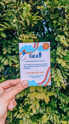 someone holding up a card with the word ocel on it in front of some bushes