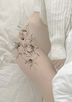 a woman's thigh with flowers on it