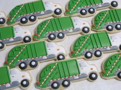 decorated cookies in the shape of trucks on a white tablecloth with red and green stripes