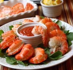 a plate with shrimp and dipping sauce on it