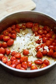 tomatoes and onions are being cooked in a pan