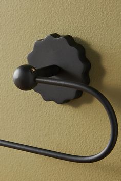 a close up of a hook on a wall with a black object attached to it