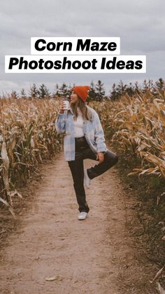 a woman standing in the middle of a corn field