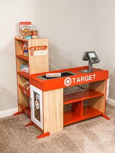 an orange target store counter in the corner of a room with bookshelves and other items