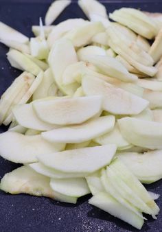 sliced apples on a cutting board ready to be cut into wedges and put in the oven