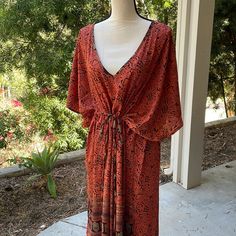 It Doesn’t Get Any Easier Than This One-Piece Dressing Caftan From Karma Highway. One Size Means It Fits Almost Everyone, Just Cinch The Waist Or Leave It Loose And Easy. With A Bandeau Or Tank Underneath, Or As A Classy Swimsuit Coverup, You Can Wear This Just About Anywhere. This Is A Beautiful Deep Melon Color. Orange V-neck Maxi Dress For Beach, Orange V-neck Maxi Dress For Festival, Bohemian Maxi Dress With Tie Waist, Orange V-neck Maxi Dress For Beach Cover-up, Orange Free Size V-neck Maxi Dress, Bohemian V-neck Kaftan With Tie Waist, Orange Printed Maxi Dress Beach Cover-up, Free Size Orange V-neck Dress, Orange Maxi Length Kaftan For Spring