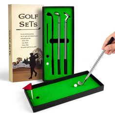 the golf set is in its box and ready to be used as a putter