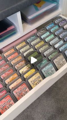 a drawer filled with lots of different colored stamps