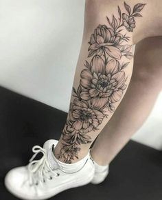 a woman's leg with flowers on it