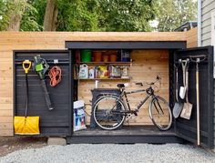 a bike is parked in the back of a storage shed with tools and other items