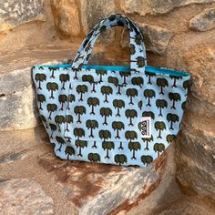 This small handbag is just what you need to walk around. Small but roomy enough to take with you all the necessary! The Kassandra bag measures roughly 22 x 37 cm (don't forget it's handmade!) and has a handy outside pocket. It's pattern is inspired by summer and beaches with its palmtrees! Our patterns are printed on a 100% polyester canvas that makes the bags strong and steady. All our bags are fully lined with a 100% cotton fabric. You'll find the cute fabric purse with the same pattern in the purse section! DESIGNED & MADE BY HAND IN ATHENS WITH LOVE CARE INSTRUCTIONS : * You can machine wash your bag at 30o or by hand * Wash it alone or with similar colors * No bleach, No tumble, No ironing Large Capacity Rectangular Lunch Bag For Summer, Summer Rectangular Fabric Shoulder Bag, Rectangular Zipper Pouch Bag For Vacation, Casual Rectangular Summer Lunch Bag, Fabric Tote Shoulder Bag For Vacation, Summer Vacation Bag In Fabric, Summer Vacation Fabric Bag, Summer Vacation Bag Made Of Fabric, Summer Rectangular Canvas Bag With Removable Pouch