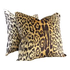 two leopard print pillows sitting on top of each other