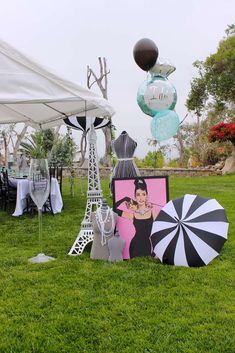 an assortment of umbrellas and decorations in the grass