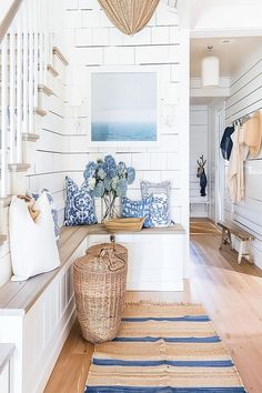 Bright and white coastal entryway with blue accents and ocean-themed artwork creating a serene atmosphere. Beach House Entryway Ideas, House Entryway Ideas, Coastal Entryway Ideas, Coastal Foyer, Beach House Entryway, House Entryway, Calm Coastal, Beach House Flooring, Coastal Entryway