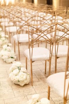 rows of chairs with white flowers on the floor