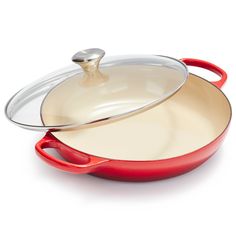 a red and white pan with a lid on the bottom is sitting in front of a white background