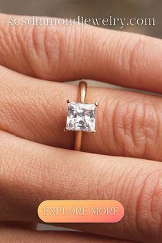 a woman's engagement ring with a princess cut diamond in the center, on her finger