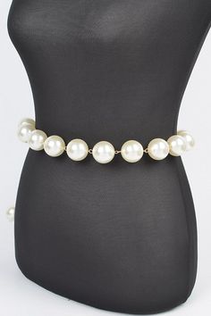 Elevate your outfit with our Iconic Pearl Station Chain Belt. Indulge in the luxury of genuine pearls and a delicate chain, adding a touch of elegance to any look. Complete your wardrobe with this timeless and sophisticated accessory. One Size Width - 1.25" Length - 50" PVC, Faux Pearl, Mix Metal Lead & Nickel Compliant Chic Pearl Necklace With Chain For Formal Events, Chic Pearl Necklace With Chain For Formal Occasions, Chic Formal Pearl Necklace With Chain, Chic Pearl Necklaces For Party, Chic Pearl White Necklace For Wedding, Chic Pearl Chain For Party, Chic Pearl Chain Jewelry For Party, Chic Beaded Chain Jewelry For Formal Occasions, Chic Pearl White Necklace With Pearl Charm