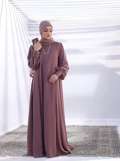 Brand New Sub-Category: Abaya Color Type: Muave Shirt Fabrics: Nidha Size:XL Top Fit: Loose Fit Front Closed Additional Description:This classic maxi abaya has a front neck zipper giving a very modern touch to the modest wear. The premium quality saudi nidah fabric is used to bring this piece to life. The abaya has balloon sleeves with cuffs. Comes with a matching scarf of standard size. Model is wearing small size and muave color. Disclaimer: Actual product color may vary slightly from the image. Abaya Online, Abaya Black, Hijab Collection, Purple Line, Basic Wear, Abaya Designs, Latest Colour, Modest Wear, Black Camel