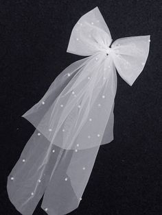 a white bow on top of a black surface