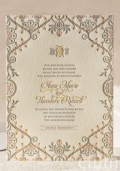 a wedding card with an ornate design on it