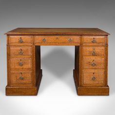 an old wooden desk with drawers on one side and a drawer at the other end