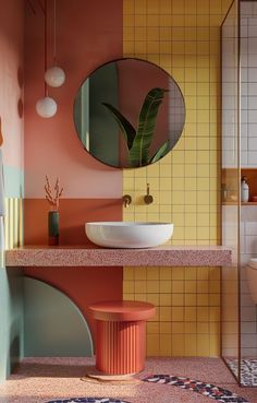 a bathroom with a sink, mirror and plant on the counter in front of it