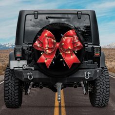 a red bow on the back of a black jeep