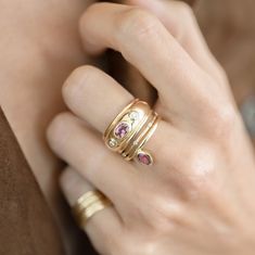 a close up of a person's hand with two rings