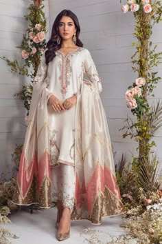 Classic Pure Raw Silk ensemble beautifully embellished with a mix of silver & gold dabka & applique work, pop of pink, green and aqua silk threads, along with pearls, sequins, beads and stone work on neckline, sleeves and hem. This classy shirt is paired with fully embellished raw silk skinny shalwar and stunning color blocked maysuri dupatta. Shirt & Shalwar Fabric: Pure Raw Silk Shirt Length: 38” Dupatta Fabric: Pure Maysuri Shirt & Shalwar color: Ivory Dupatta color: Ivory, pink & Bronze All Stylish Frocks, Designer Outfit, Applique Work, Eid Outfits, Boutique Dress Designs, Pakistani Designers, Designer Dresses Indian, 2023 Fashion, Stone Work