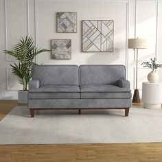 a living room scene with focus on the couch and rug, which has been placed in front of a white wall