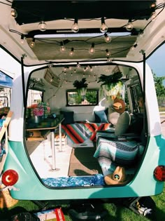 the interior of an old camper van is decorated with lights and stuffed animal toys