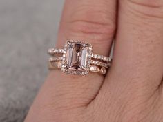 a woman's hand with a ring on it and an emerald stone in the middle