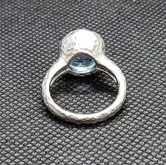 14k solid white gold hammered ring with 0.15 ct. SI1, G color natural brilliant diamonds & 4.0 ct. 10 mm round shape natural AAA Swiss blue topaz. This item can also be ordered in rose or yellow gold with different color gemstones such as London blue topaz, green amethyst, pink amethyst, citrine, smoky quartz, white topaz, garnet, peridot, morganite & aquamarine. Please contact me for a quote as each gemstone varies in price. I am a manufacturer of fine jewelry for over thirty years, cus Hammered Ring, Hammered Rings, Morganite Ring, Swiss Blue Topaz, Pink Amethyst, Green Amethyst, Yellow Sapphire, London Blue Topaz, London Blue