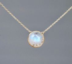 Lovely genuine AA blue moonstone is set in 14k gold. A very unique necklace where the moonstone itself is studded with diamonds in a stone on stone setting.  Size : 12mm Metal : 14kt Gold (choose color from dropdown) Gemstones : 13 cts Rainbow Moonstone 0.03 cts F, SI White Diamonds Packaging : All products purchased from us come in a gift box. If you need to include a message, kindly leave us a note when purchasing.  Care Recommendations:  Opal jewelry can be cleaned at home by using a soft clo Moon Shaped Rose Cut Diamond Jewelry Gift, Fine Jewelry With Single Cut Diamonds And Moonstone, Moonstone Jewelry With Rose Cut Diamonds, Round Moonstone Jewelry With Rose Cut Diamonds, Rose Cut Diamonds Moonstone Round Jewelry, White Moonstone Jewelry With Single Cut Diamonds, Luxury Moonstone Necklace With Gemstones, Moonstone Necklaces With Gemstone Accents, Round Moonstone Necklace With Gemstone Accents