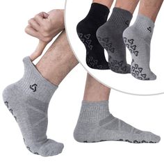 three pairs of men's socks with hearts and arrows on the bottom, one in grey