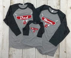 two gray and black shirts with red letters that say dad and me on the front