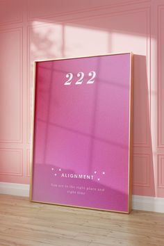 a pink poster frame with the number 22 on it in front of a pink wall