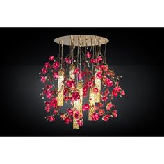 a chandelier with red flowers hanging from it's sides and gold trimmings